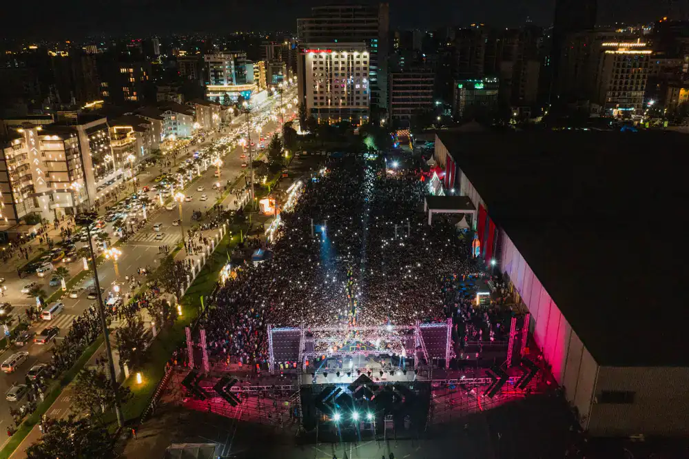 Players competing on a large neon-lit stage